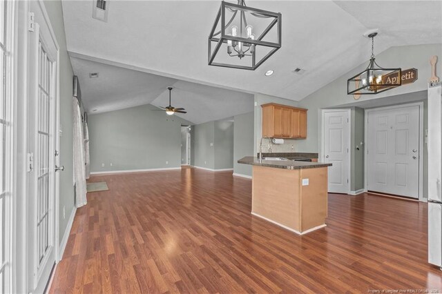 2720 Daniel Boone Ln, Hope Mills, NC 28348 - kitchen with a chandelier, vaulted ceiling, dark countertops, open floor plan, and a peninsula
