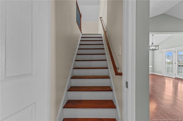 2720 Daniel Boone Ln, Hope Mills, NC 28348 - staircase featuring vaulted ceiling, wood finished floors, and a chandelier