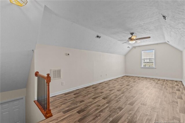 2720 Daniel Boone Ln, Hope Mills, NC 28348 - bonus room with ceiling fan, wood finished floors, vaulted ceiling, and a textured ceiling