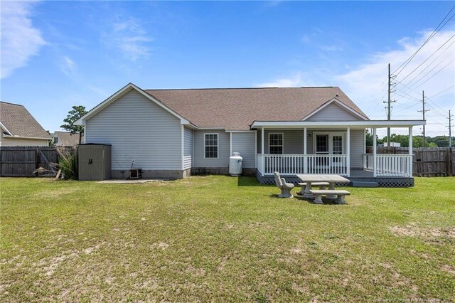 2720 Daniel Boone Ln, Hope Mills, NC 28348 - rear view of house with a fenced backyard, a shed, covered porch, and roof with shingles
