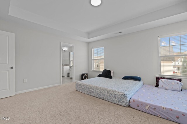 2346 Mckenzie Ridge Ln, Apex, NC 27502 - carpeted bedroom with a tray ceiling and ensuite bath