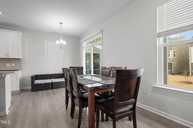 2346 Mckenzie Ridge Ln, Apex, NC 27502 - dining space with a chandelier, plenty of natural light, and light wood-style flooring