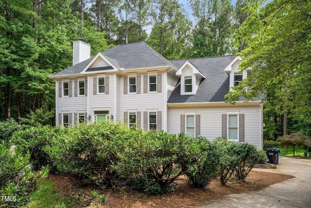 5809 N Hawthorne Way, Raleigh, NC 27603 - view of front of home with roof with shingles, a chimney, and view of scattered trees