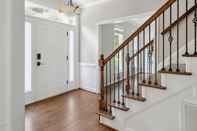 5809 N Hawthorne Way, Raleigh, NC 27603 - entryway with wood finished floors, ornamental molding, healthy amount of natural light, and stairs