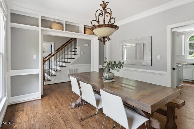 5809 N Hawthorne Way, Raleigh, NC 27603 - dining area featuring stairway, wood finished floors, and ornamental molding