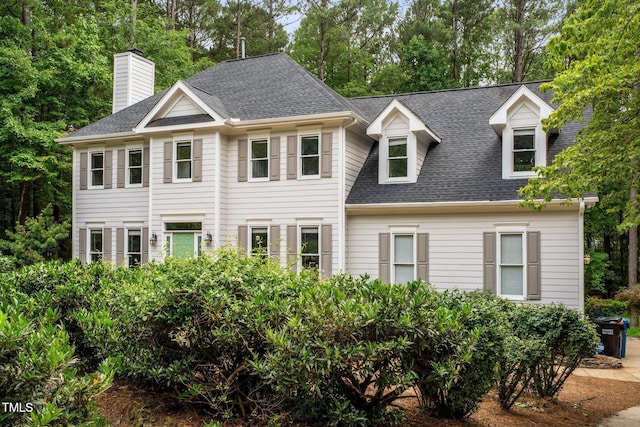 5809 N Hawthorne Way, Raleigh, NC 27603 - view of front of home featuring a shingled roof, view of scattered trees, and a chimney