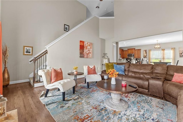 5135 Paul Peel Pl, Hope Mills, NC 28348 - living room with stairs, light wood-type flooring, and a towering ceiling