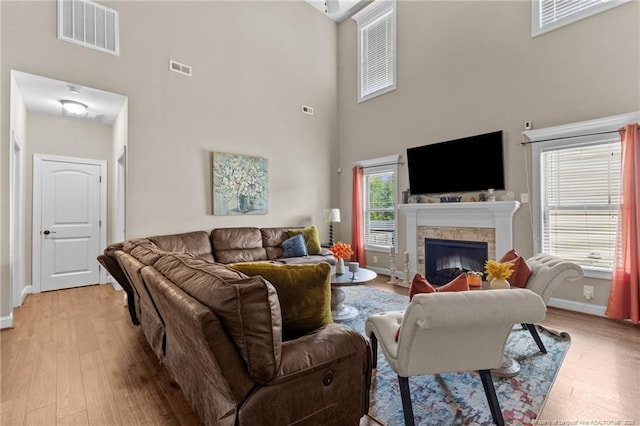 5135 Paul Peel Pl, Hope Mills, NC 28348 - living room featuring a high ceiling, light wood-type flooring, and a fireplace