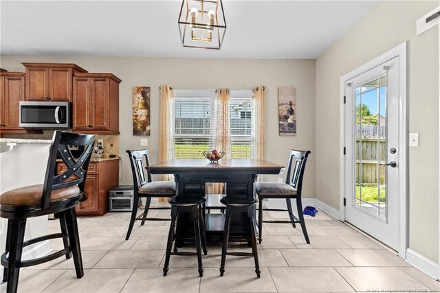 5135 Paul Peel Pl, Hope Mills, NC 28348 - dining room featuring light tile patterned flooring and a chandelier