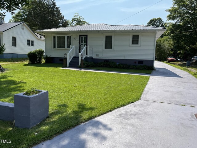 129 S Bullock St, Henderson, NC 27536 - view of front of home featuring crawl space, a front lawn, and a metal roof
