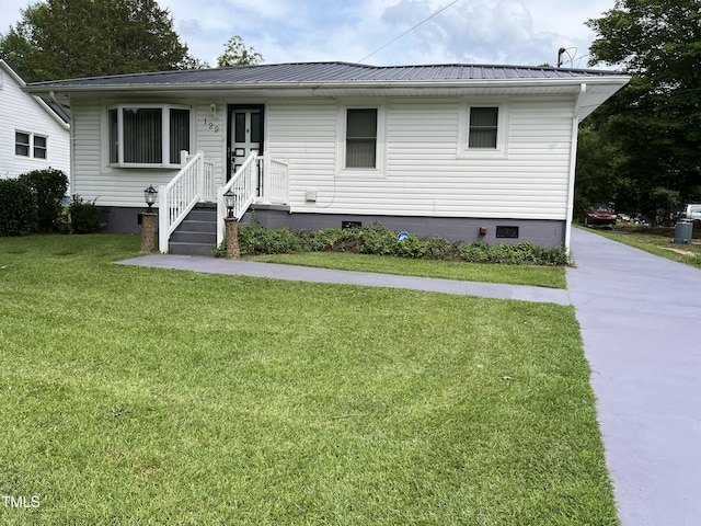 129 S Bullock St, Henderson, NC 27536 - view of front facade featuring crawl space, a front lawn, and a metal roof