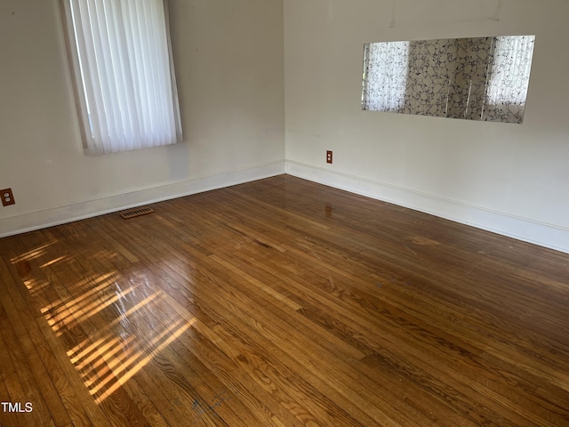 129 S Bullock St, Henderson, NC 27536 - empty room featuring dark wood finished floors and baseboards