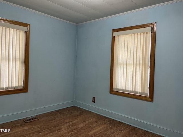 129 S Bullock St, Henderson, NC 27536 - unfurnished room featuring healthy amount of natural light, ornamental molding, and dark wood-style flooring