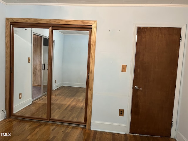 129 S Bullock St, Henderson, NC 27536 - unfurnished bedroom with wood finished floors and crown molding