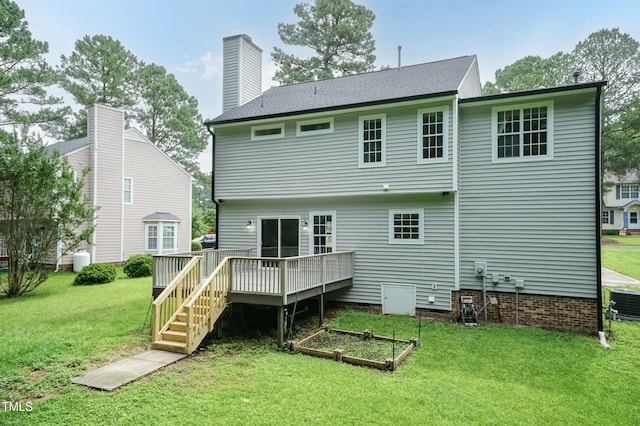 3110 Trinness Dr, Durham, NC 27707 - rear view of house featuring a wooden deck, a yard, and a chimney