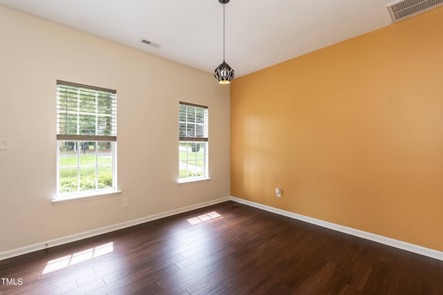 3110 Trinness Dr, Durham, NC 27707 - unfurnished room featuring plenty of natural light and dark wood-style flooring