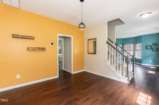 3110 Trinness Dr, Durham, NC 27707 - empty room with dark wood-style flooring, a chandelier, and stairway