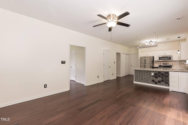 3110 Trinness Dr, Durham, NC 27707 - unfurnished living room with ceiling fan and dark wood-style floors
