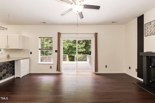 3110 Trinness Dr, Durham, NC 27707 - unfurnished living room featuring a ceiling fan and dark wood-style flooring