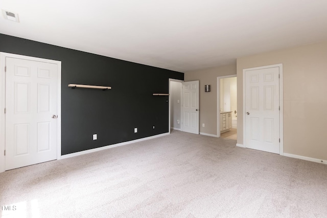 3110 Trinness Dr, Durham, NC 27707 - unfurnished bedroom featuring light carpet and connected bathroom