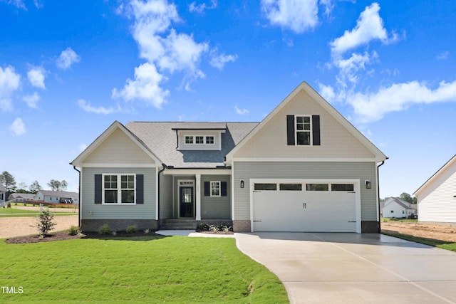 222 Cherrybirch Ln, Zebulon, NC 27597 - craftsman inspired home featuring driveway, a front lawn, a garage, and roof with shingles