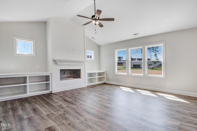 222 Cherrybirch Ln, Zebulon, NC 27597 - unfurnished living room featuring a fireplace, vaulted ceiling, ceiling fan, and wood finished floors