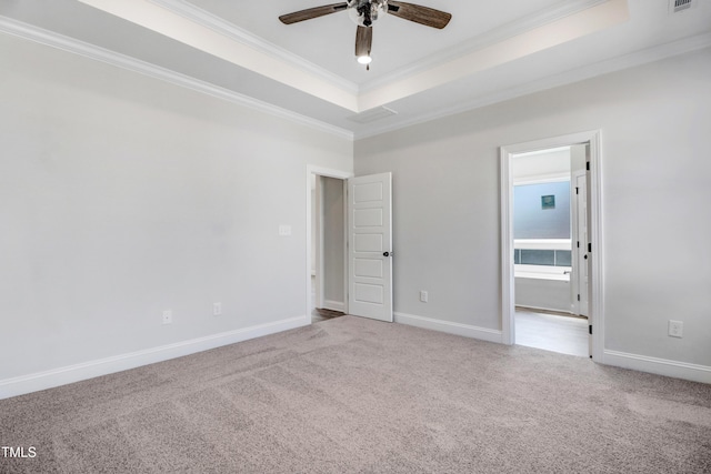 222 Cherrybirch Ln, Zebulon, NC 27597 - carpeted empty room with crown molding, ceiling fan, and a raised ceiling