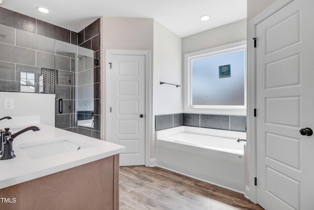 222 Cherrybirch Ln, Zebulon, NC 27597 - bathroom with a garden tub, double vanity, wood finished floors, tiled shower, and recessed lighting