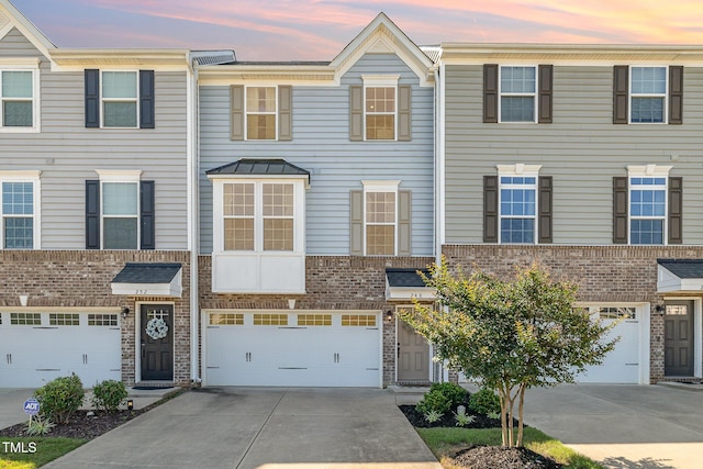 248 Amber Acorn Ave, Raleigh, NC 27603 - townhome / multi-family property with driveway, an attached garage, and brick siding
