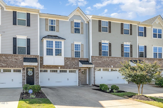 248 Amber Acorn Ave, Raleigh, NC 27603 - view of property featuring driveway, brick siding, and an attached garage