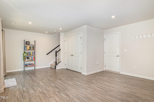 248 Amber Acorn Ave, Raleigh, NC 27603 - below grade area with stairs, light wood-style flooring, and recessed lighting
