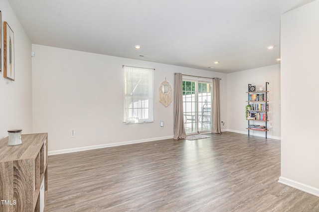 248 Amber Acorn Ave, Raleigh, NC 27603 - unfurnished living room featuring wood finished floors and recessed lighting