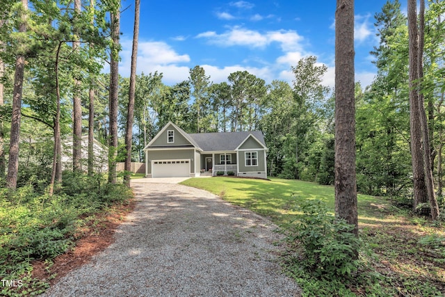 3909 Bristlewood Dr, Durham, NC 27703 - view of front of home featuring gravel driveway, an attached garage, board and batten siding, a front lawn, and covered porch
