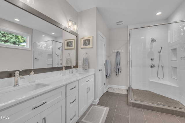 3909 Bristlewood Dr, Durham, NC 27703 - bathroom with a shower stall, double vanity, recessed lighting, and tile patterned floors