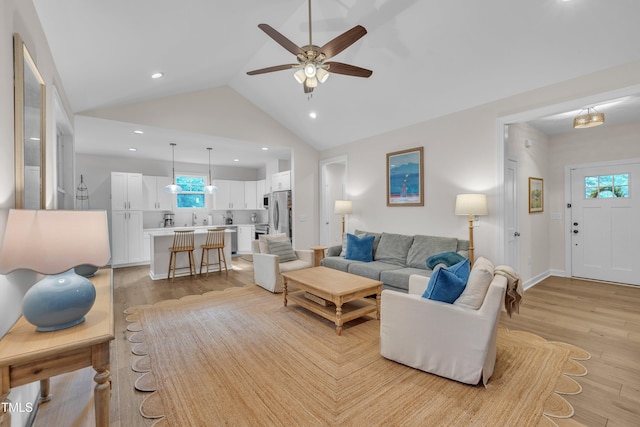 3909 Bristlewood Dr, Durham, NC 27703 - living area featuring light wood finished floors, ceiling fan, vaulted ceiling, and recessed lighting