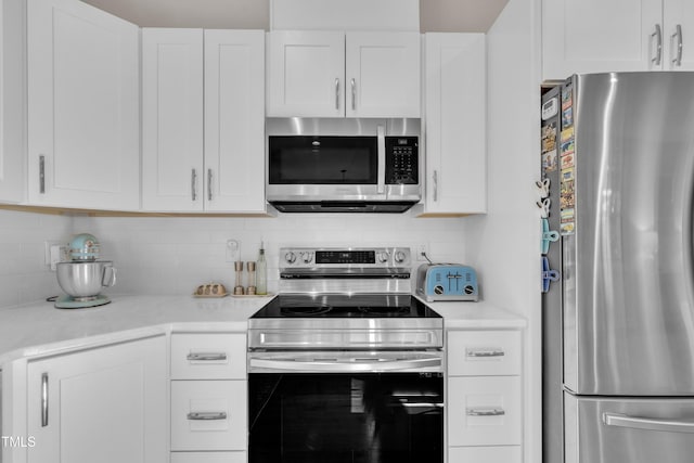 3909 Bristlewood Dr, Durham, NC 27703 - kitchen with appliances with stainless steel finishes, light countertops, decorative backsplash, and white cabinetry