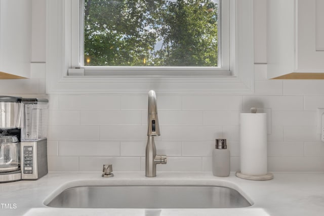 3909 Bristlewood Dr, Durham, NC 27703 - kitchen view of tasteful backsplash, light countertops, and white cabinetry