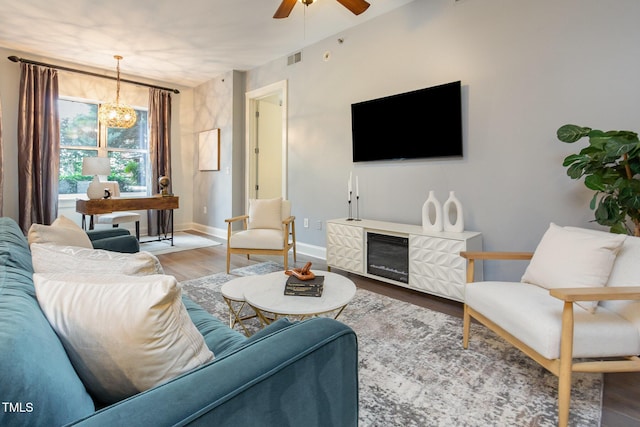 618 N Boylan Ave Unit 520, Raleigh, NC 27603 - living room featuring wood finished floors, a ceiling fan, a chandelier, and wine cooler