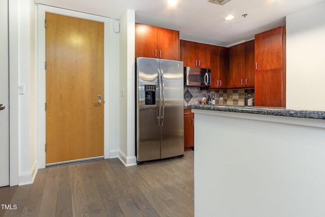 618 N Boylan Ave Unit 520, Raleigh, NC 27603 - kitchen featuring stainless steel appliances, dark wood-type flooring, tasteful backsplash, dark countertops, and recessed lighting