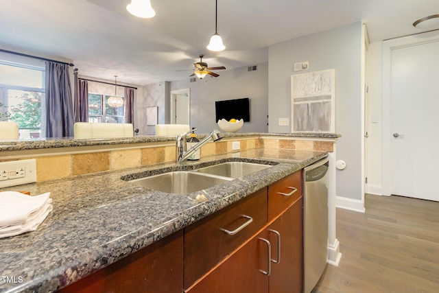 618 N Boylan Ave Unit 520, Raleigh, NC 27603 - kitchen with dishwasher, dark stone counters, light wood-type flooring, hanging light fixtures, and a ceiling fan