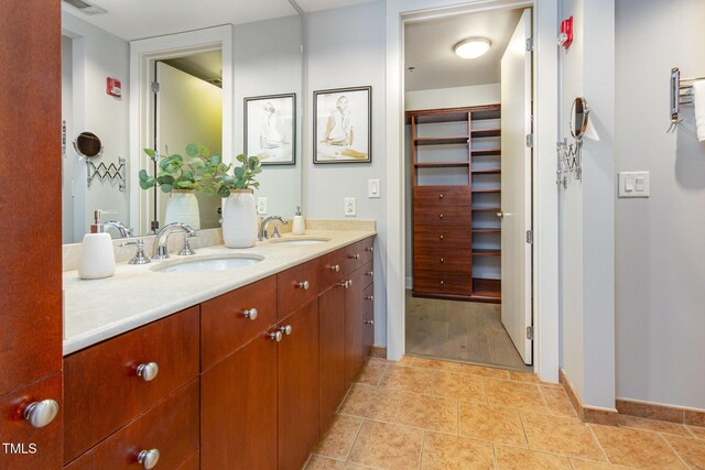618 N Boylan Ave Unit 520, Raleigh, NC 27603 - full bathroom featuring double vanity, a spacious closet, and tile patterned flooring