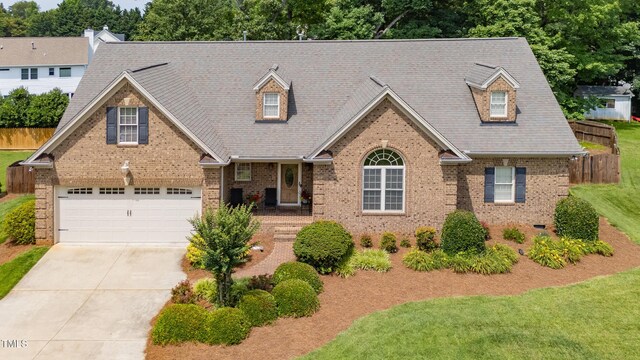 412 Whitt Ave, Burlington, NC 27215 - new england style home with brick siding, driveway, and an attached garage