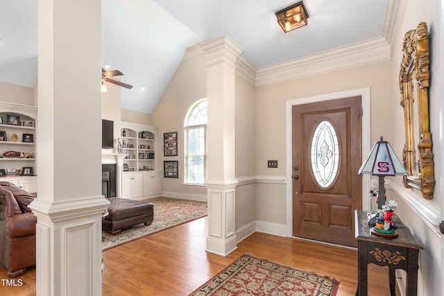 412 Whitt Ave, Burlington, NC 27215 - foyer entrance featuring ornate columns, ceiling fan, light wood-style flooring, a fireplace, and high vaulted ceiling