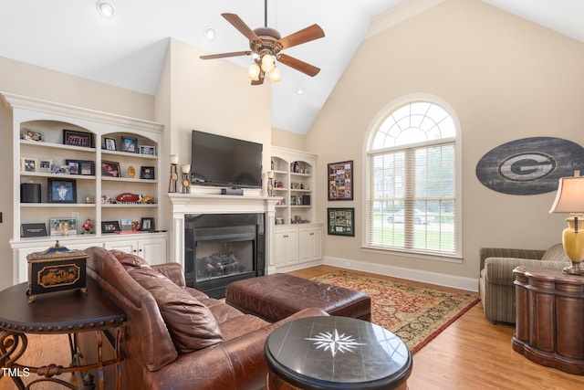 412 Whitt Ave, Burlington, NC 27215 - living room with a ceiling fan, high vaulted ceiling, a fireplace, wood finished floors, and built in features
