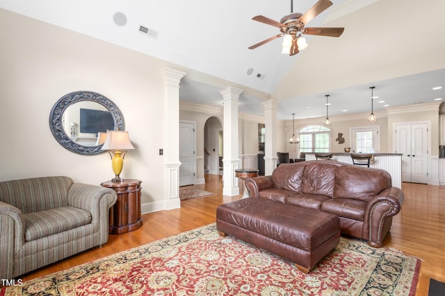 412 Whitt Ave, Burlington, NC 27215 - living room with light wood-style flooring, crown molding, a ceiling fan, decorative columns, and arched walkways