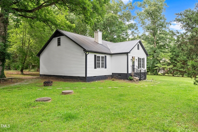 2809 Titleist Dr, Hillsborough, NC 27278 - view of side of home featuring crawl space, a fire pit, a metal roof, a chimney, and a lawn