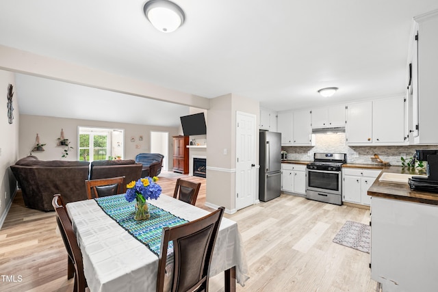 2809 Titleist Dr, Hillsborough, NC 27278 - dining space featuring light wood-style floors and a fireplace