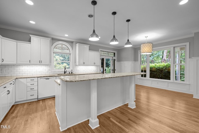 300 Oak Ridge Dr, Hillsborough, NC 27278 - kitchen featuring dishwasher, a center island, white cabinets, light wood-style flooring, and backsplash