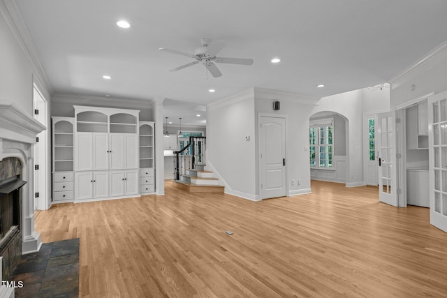 300 Oak Ridge Dr, Hillsborough, NC 27278 - unfurnished living room with a fireplace with flush hearth, a ceiling fan, stairs, crown molding, and light wood-type flooring