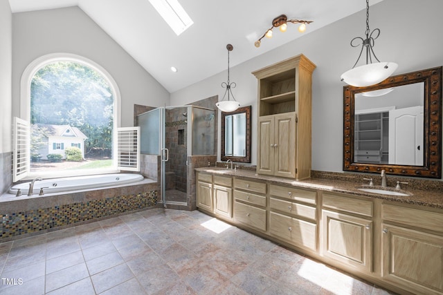 300 Oak Ridge Dr, Hillsborough, NC 27278 - bathroom featuring a skylight, double vanity, a stall shower, a bath, and vaulted ceiling